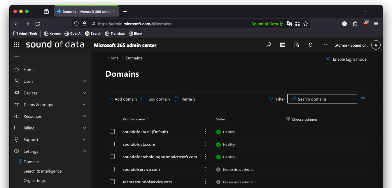 Microsoft 365 admin center Domains page on the carrier tenant, with the base domain in the list